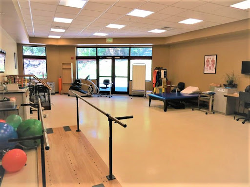 A spacious and well-equipped physical therapy room designed for rehabilitation exercises.
