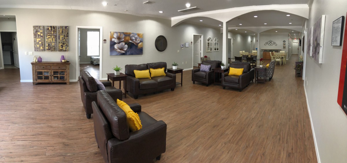 A modern waiting room with cozy sofas, colorful cushions, and stylish decor.