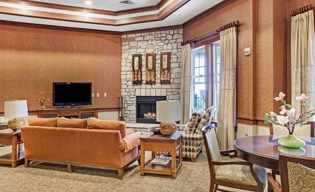 A cozy living room featuring a fireplace, television, and comfortable seating.