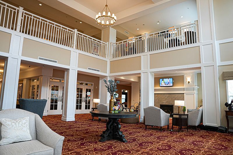 A spacious and elegant hotel lobby with comfortable seating and a chandelier.