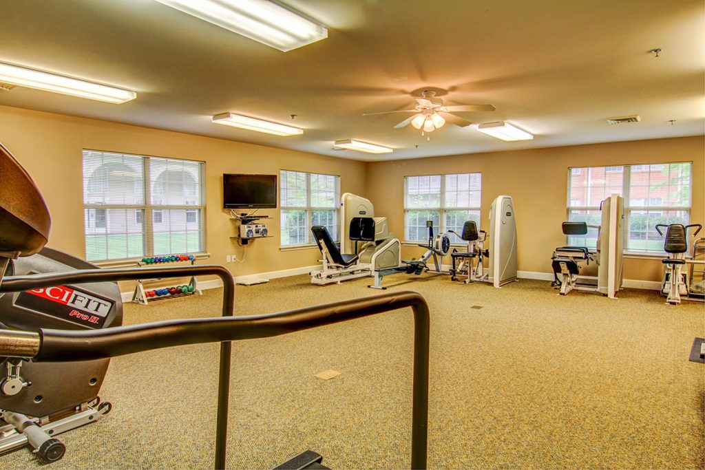 A spacious indoor gym with various exercise equipment, including treadmills and stationary bikes.