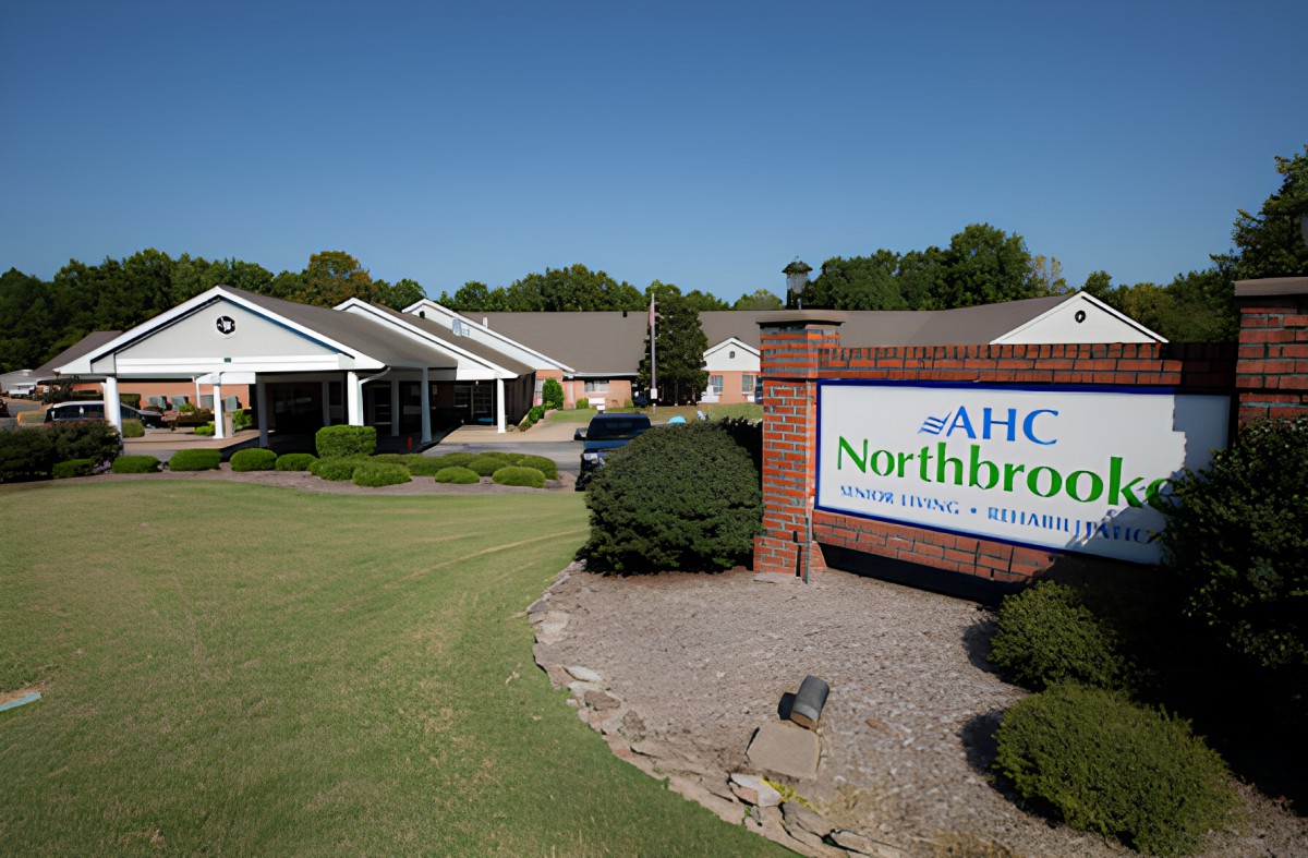 A healthcare facility with a sign reading 'AHC Northbrook' under a clear blue sky.