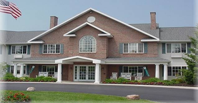 A two-story brick house with a gabled roof and a front porch.