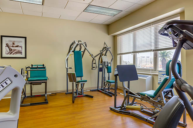 A small gym area with exercise machines and fitness equipment.