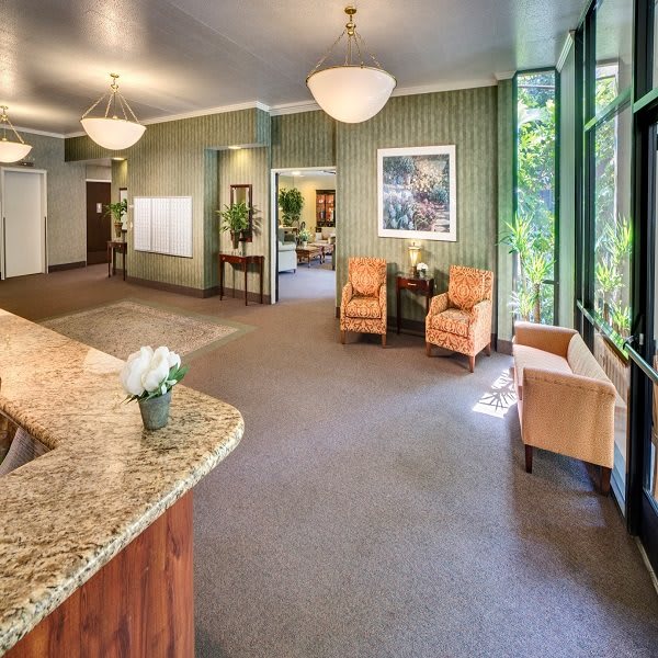 A modern, spacious lobby with a reception desk and comfortable seating.