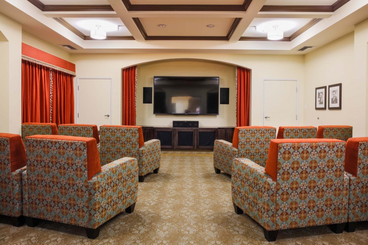 A cozy home theater room with comfortable seating and a large screen for entertainment.