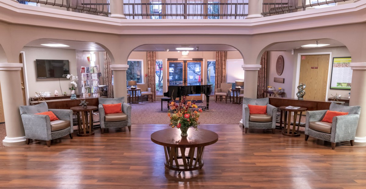 Elegant hotel lobby with a grand piano and comfortable seating.