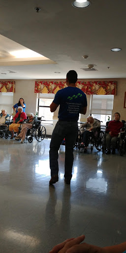 A speaker engages with residents in an assisted living facility.