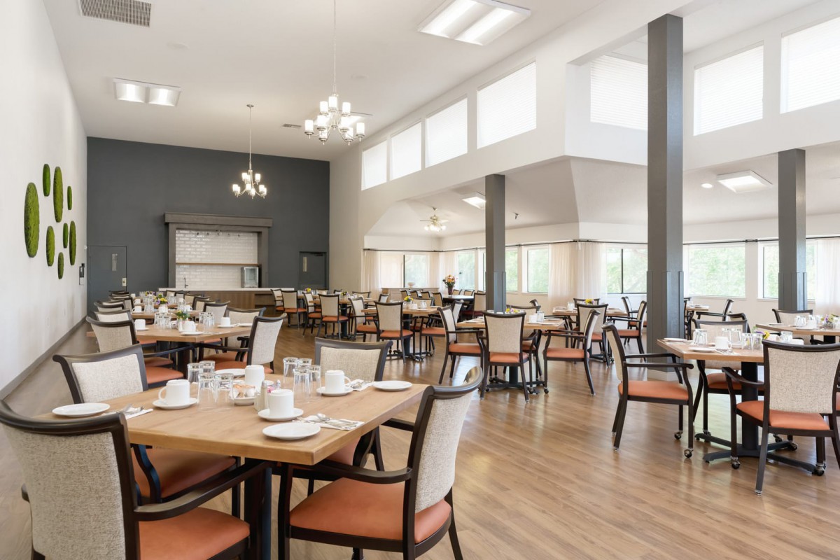 Modern dining area with neatly arranged tables and chairs.