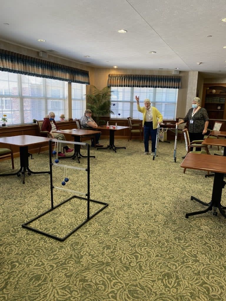 A group of seniors enjoying a game in a spacious indoor setting.