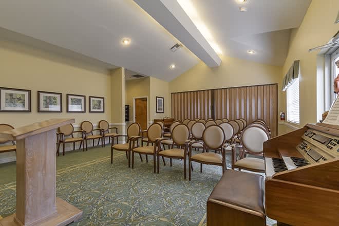 An empty conference room with neatly arranged chairs and wall art.