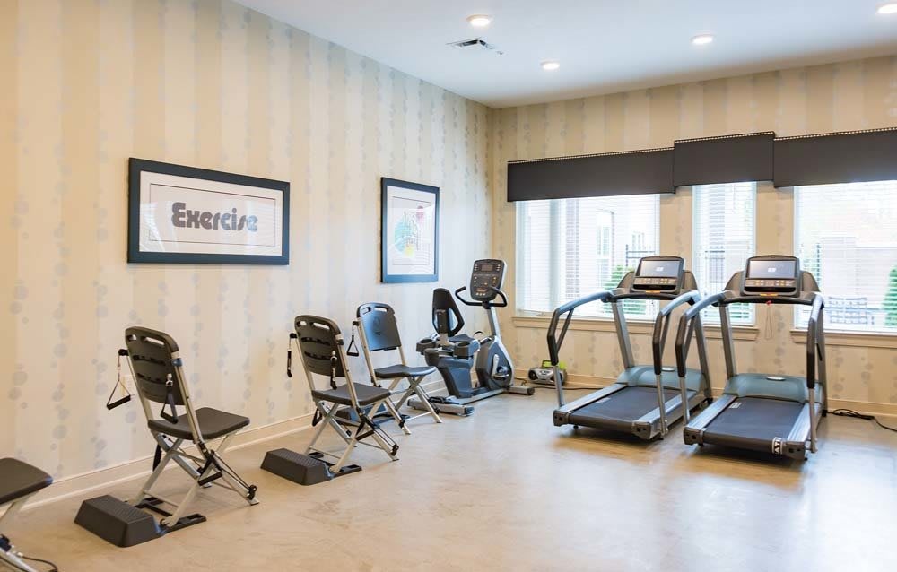 A well-equipped gym with treadmills and stationary bikes.