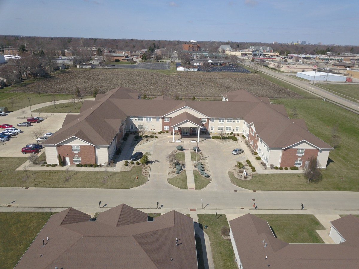 An aerial view of a college campus with parking lots and surrounding buildings.