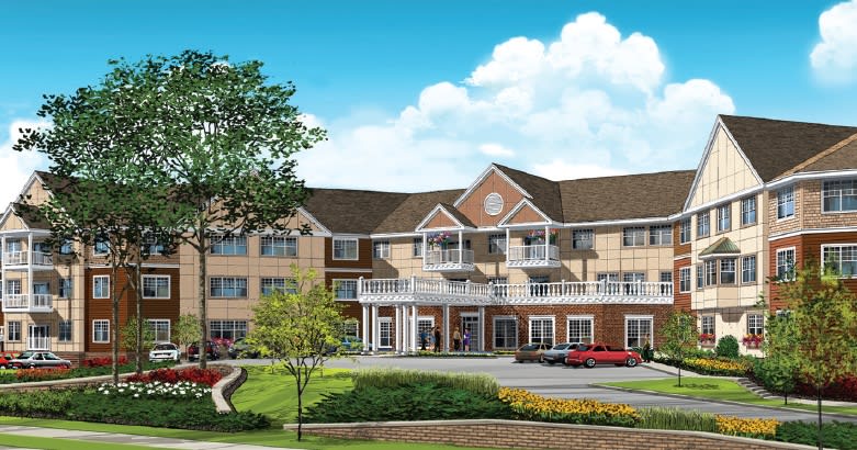A large, elegant residential building with manicured landscaping and a bright blue sky.