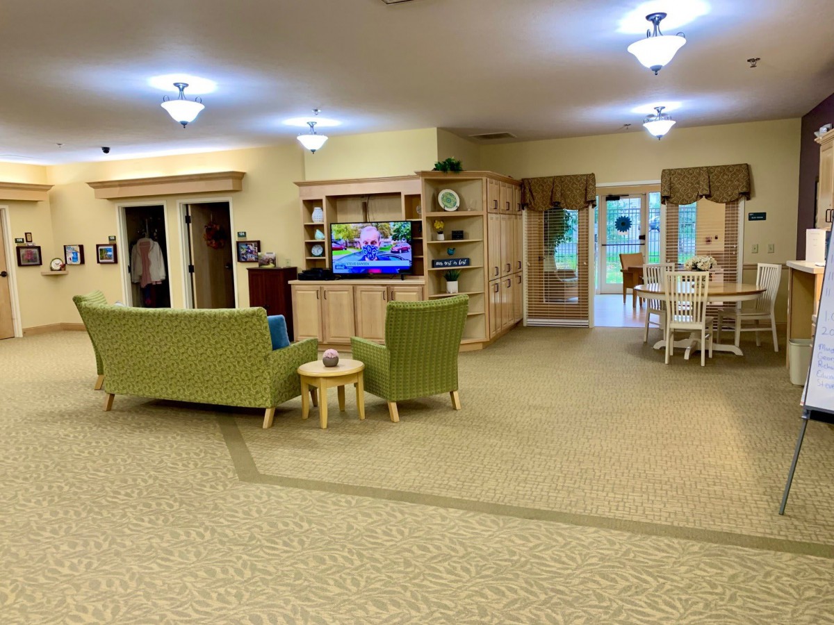 Spacious living room with seating area and entertainment center.