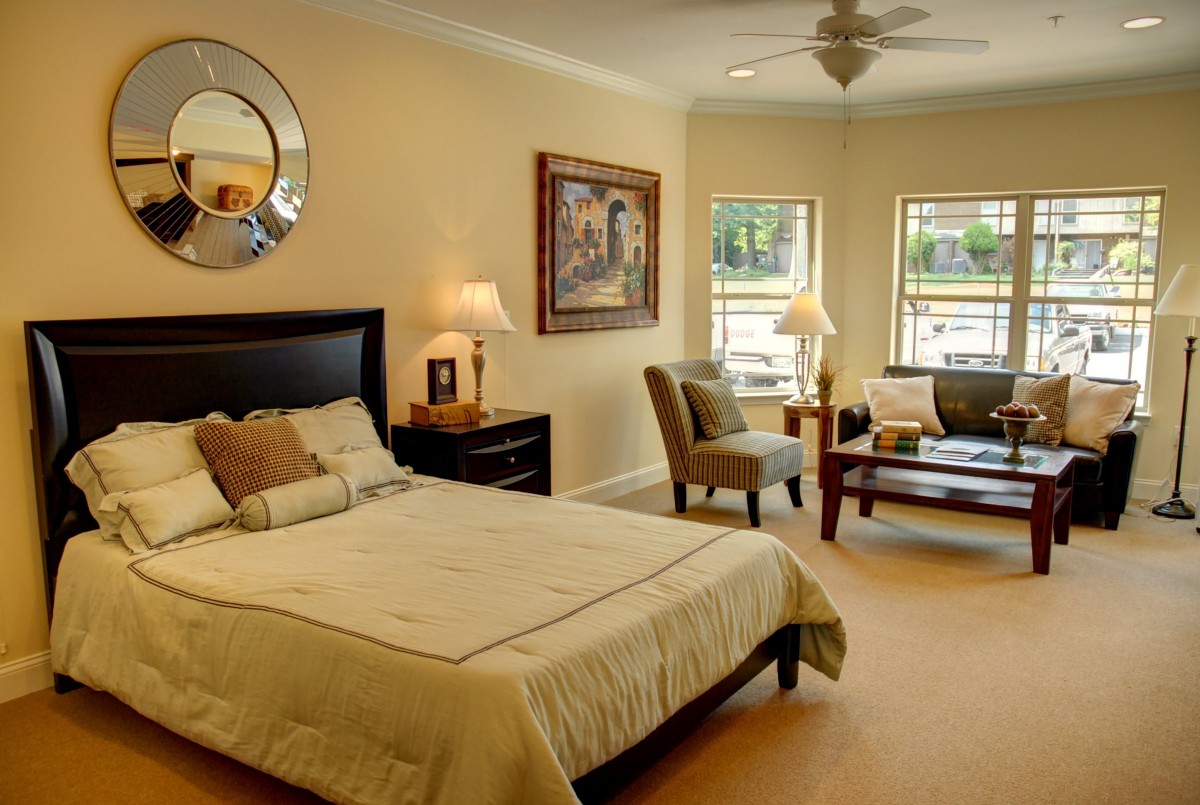 A cozy bedroom with a comfortable bed, stylish furniture, and warm lighting.