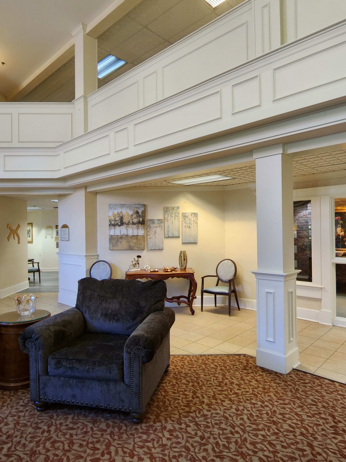 A well-lit hotel lobby with comfortable seating and elegant architectural details.