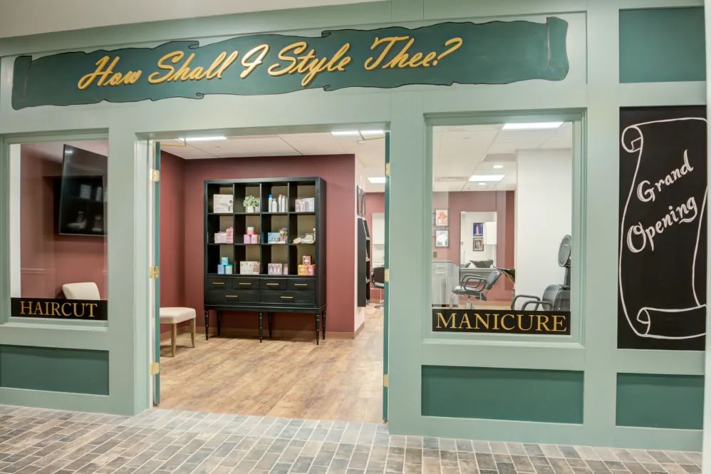 A beauty salon storefront with a sign that reads 'Manicure' and a decorative interior.