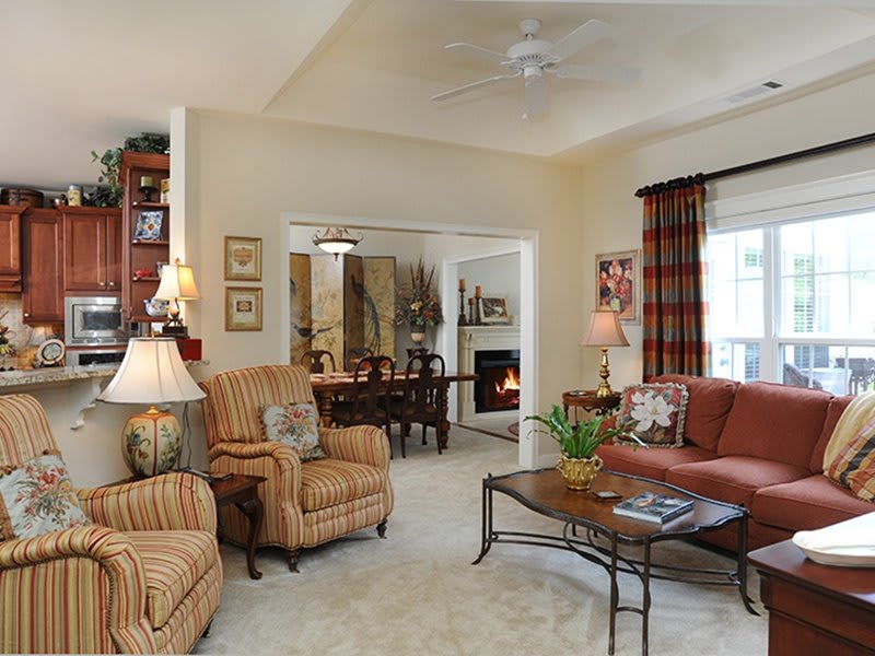 A cozy living room with a warm and inviting atmosphere, featuring comfortable seating, elegant decor, and soft lighting.