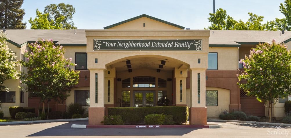 The front entrance of a building labeled 'Your Neighborhood Extended Family'.