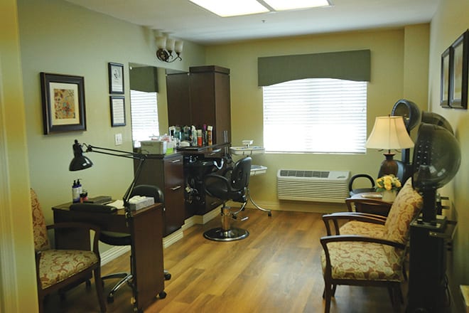 A cozy hair salon interior with styling chairs and equipment.
