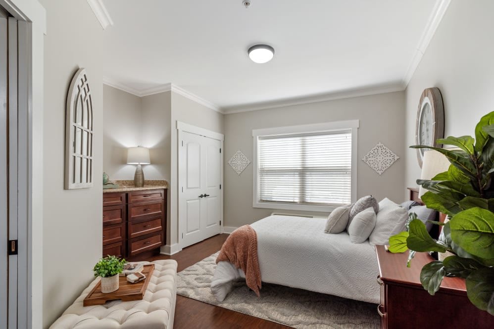 A modern and cozy bedroom with elegant furnishings and ample natural light.