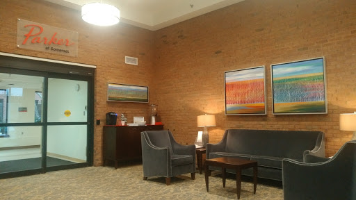 A cozy lobby area featuring comfortable seating and decorative artwork.