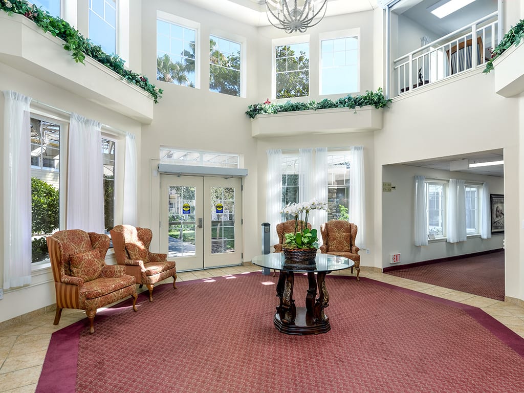 Spacious lobby with elegant furniture and large windows.