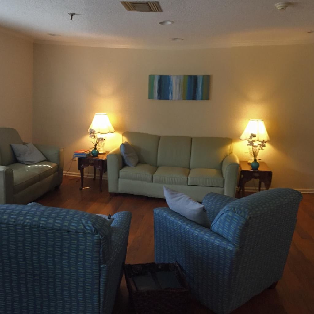 A cozy living room with comfortable seating and warm lighting.