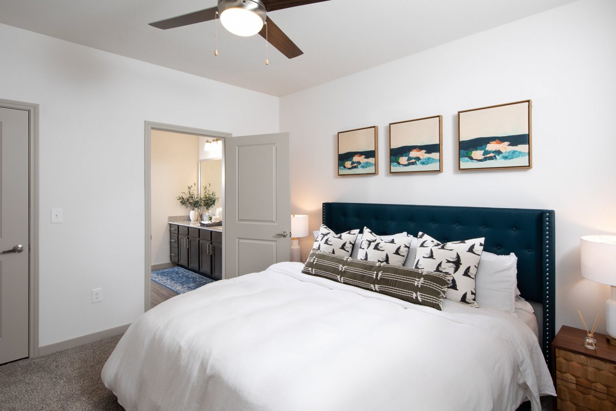 Modern bedroom with stylish decor and an adjoining bathroom.