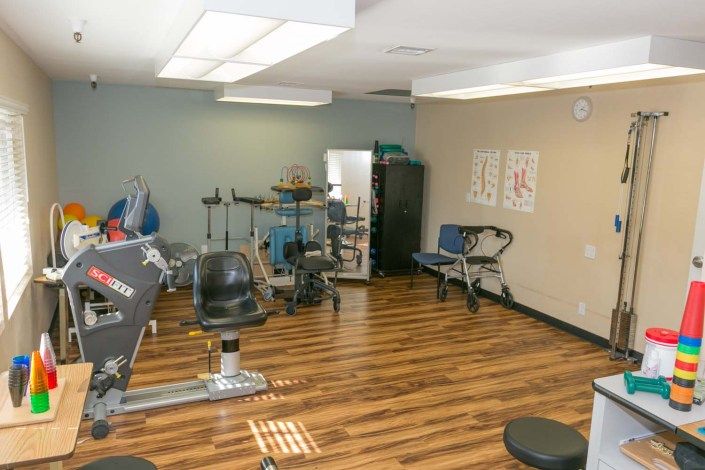 A physical therapy room with various exercise equipment for rehabilitation.