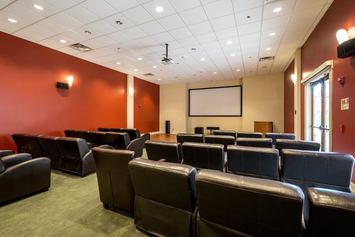 A cozy theater room with comfortable seating and a large screen.