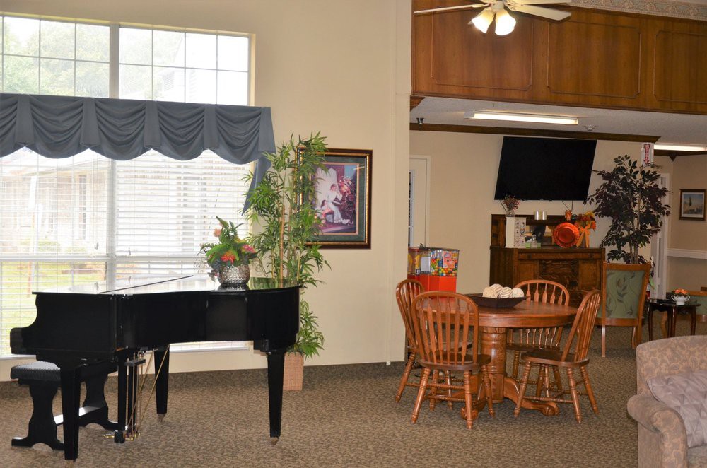 A cozy living space with a piano and dining area.