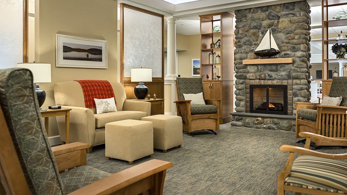 A cozy living room featuring a stone fireplace and comfortable seating.