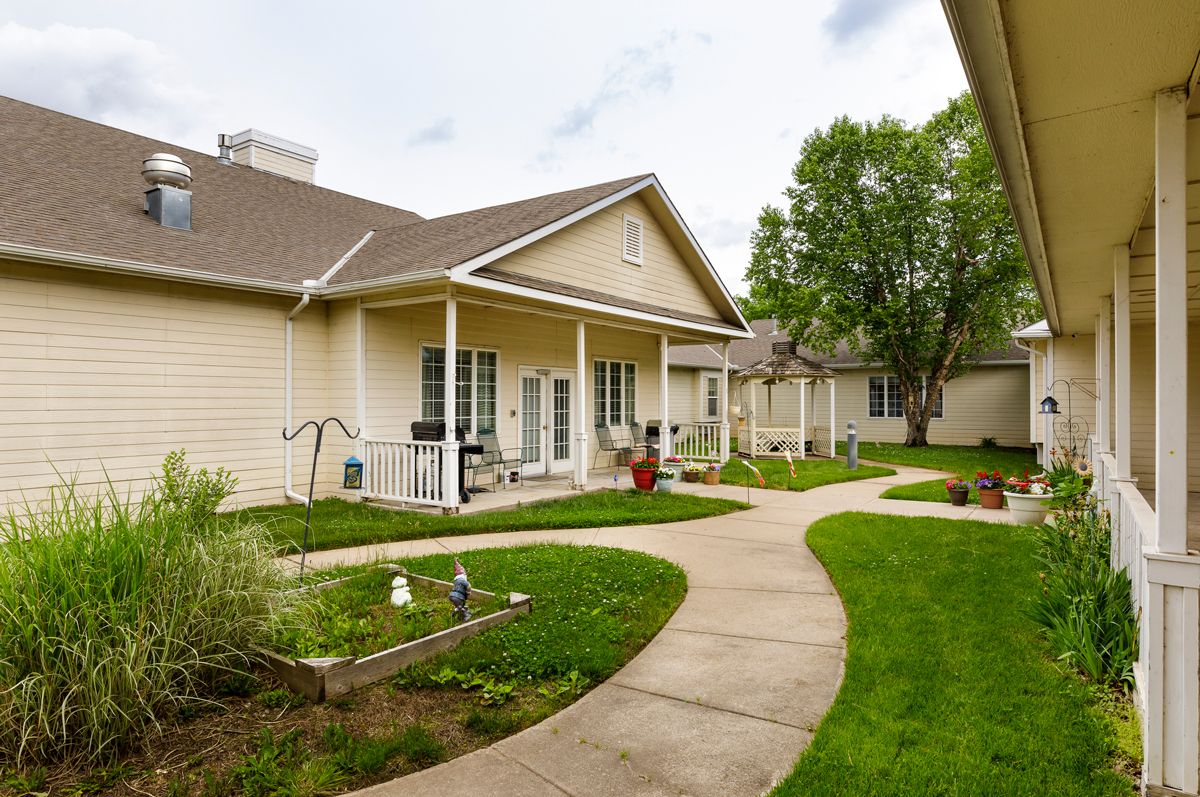 A view of a residential house with a well-maintained lawn and pathway.