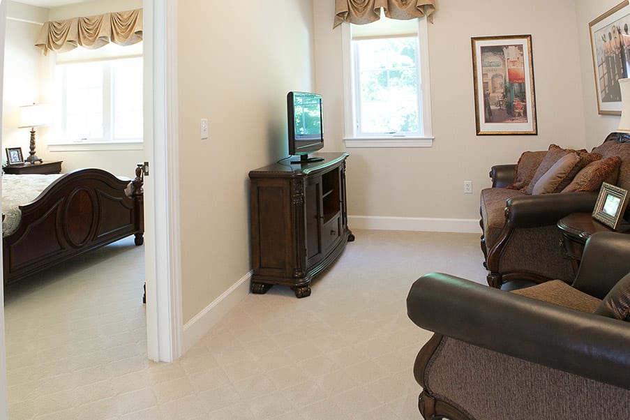 A cozy living room with a television and comfortable seating.