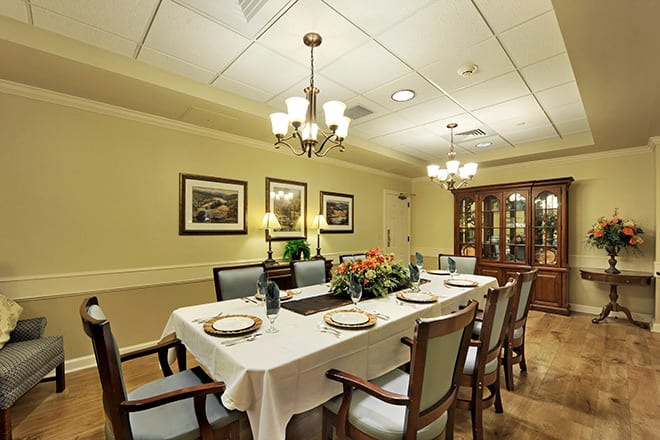 A beautifully set dining room with a long table and elegant decor.