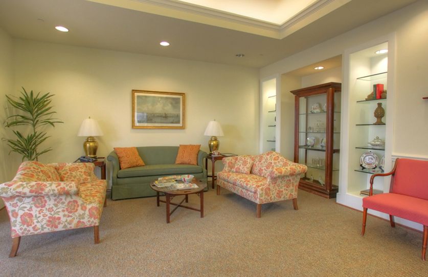A cozy living room with sofas, armchairs, a coffee table, and decorative elements.