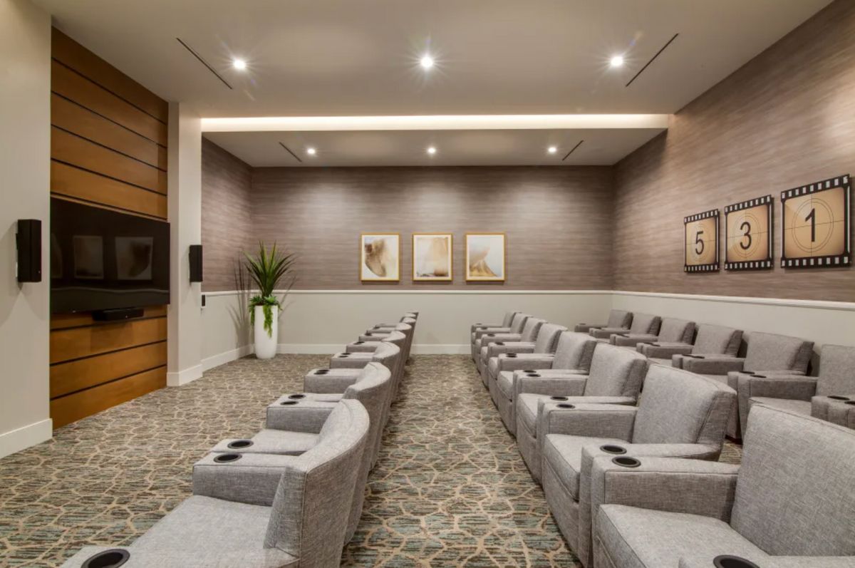 A modern theater room with comfortable seating and minimalist decor.