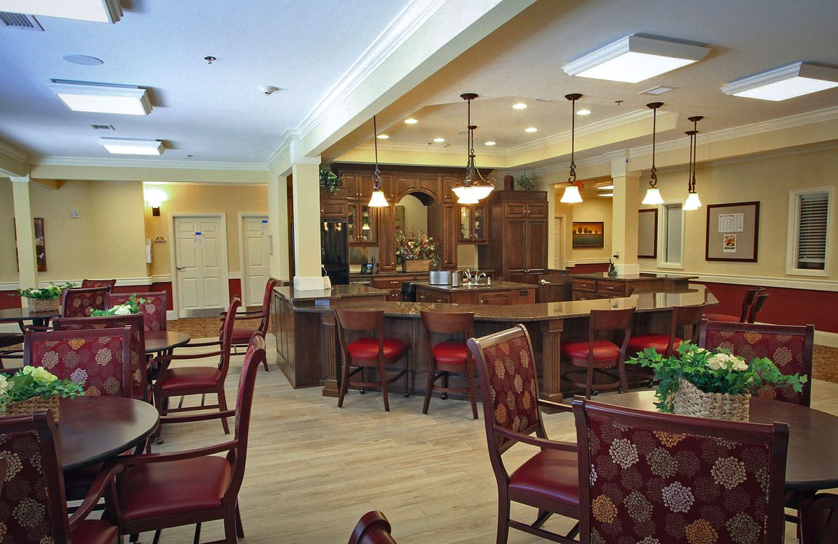 A warm and inviting dining area with a bar, featuring elegant seating arrangements and ambient lighting.
