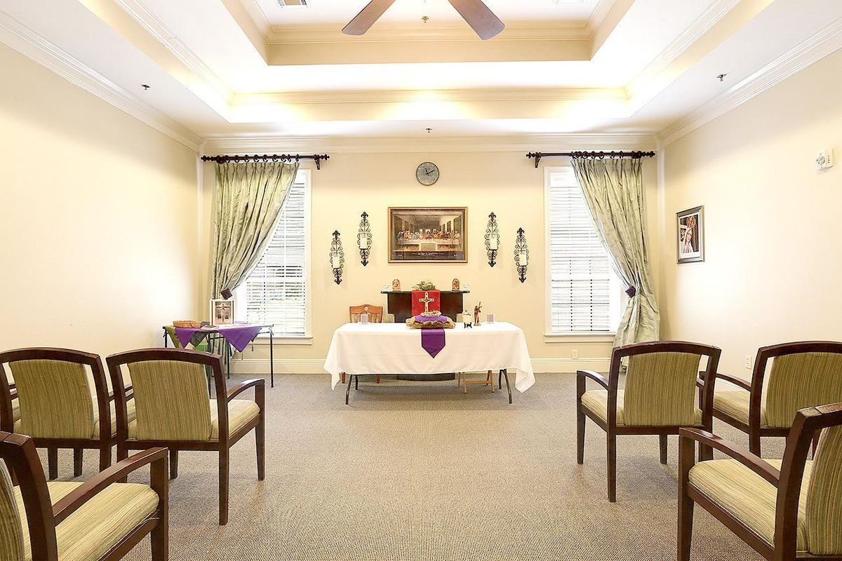 A peaceful chapel interior with an altar and arranged seating.