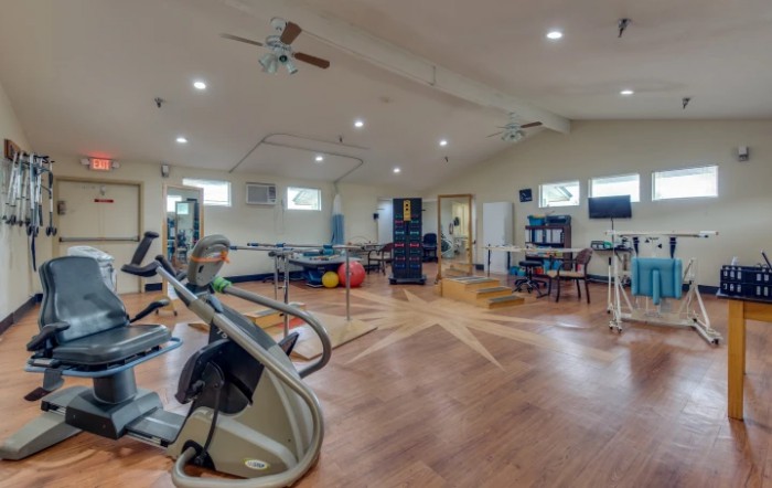 A spacious gym equipped with various fitness machines and exercise equipment.