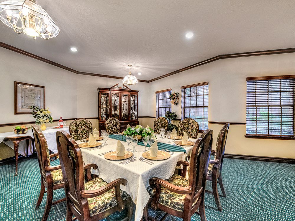 A well-decorated dining room with an elegant table setting and chandelier.