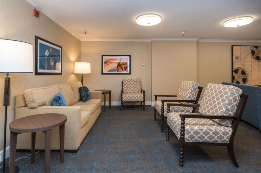 A comfortable waiting room with a sofa and chairs arranged neatly.