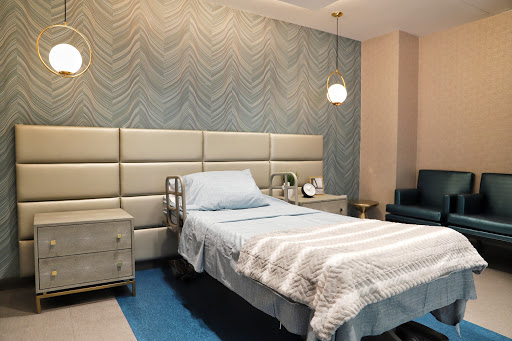 A modern and minimalist bedroom featuring a single bed and stylish decor.