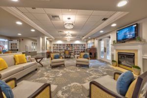 A modern and cozy library interior with comfortable seating and well-organized bookshelves.