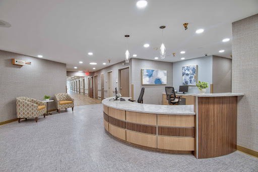 A contemporary medical office reception area featuring a spacious layout and inviting design.
