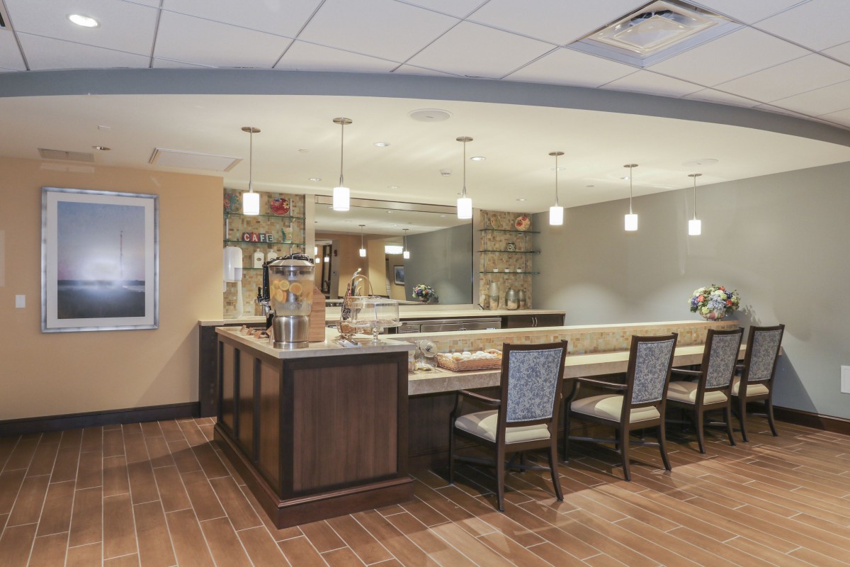 A modern lounge with bar seating and stylish lighting.