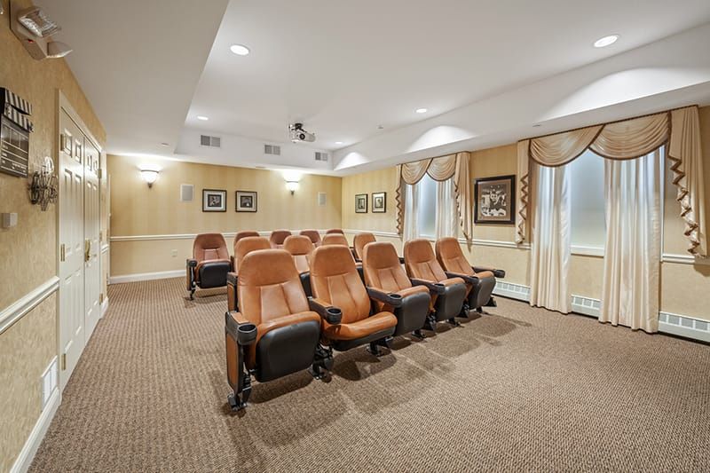 A cozy home theater room with comfortable seating and a projector.