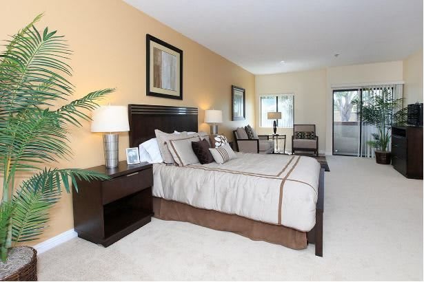 A modern, cozy bedroom with elegant decor and neutral tones.